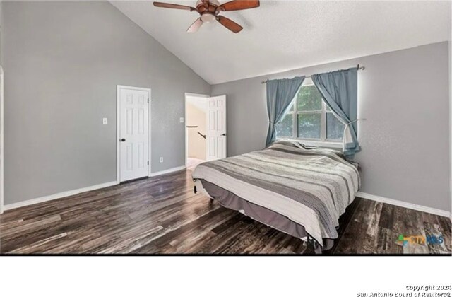 bedroom with ceiling fan, dark hardwood / wood-style flooring, and high vaulted ceiling