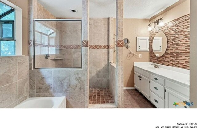 bathroom with vanity, tile patterned floors, and independent shower and bath