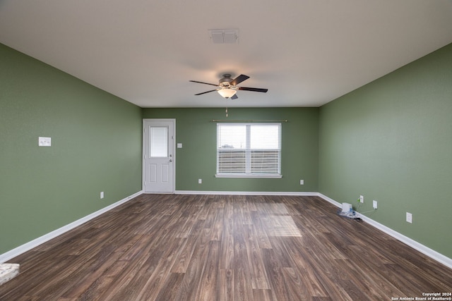 unfurnished room featuring ceiling fan and dark hardwood / wood-style flooring