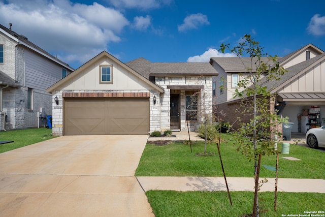 view of front of property featuring a garage and a front yard