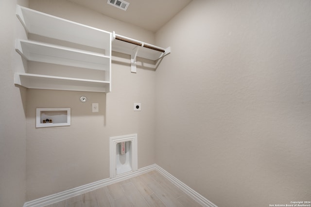 washroom featuring electric dryer hookup, gas dryer hookup, hookup for a washing machine, and light wood-type flooring