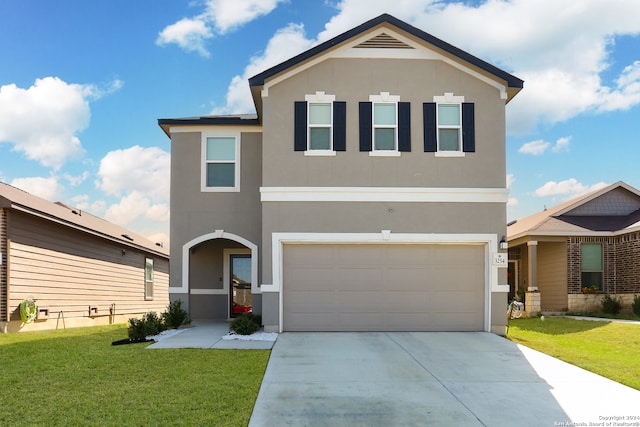 view of property featuring a front yard and a garage