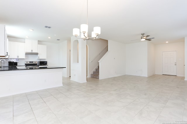 kitchen with stainless steel electric range, white cabinets, ceiling fan with notable chandelier, hanging light fixtures, and decorative backsplash