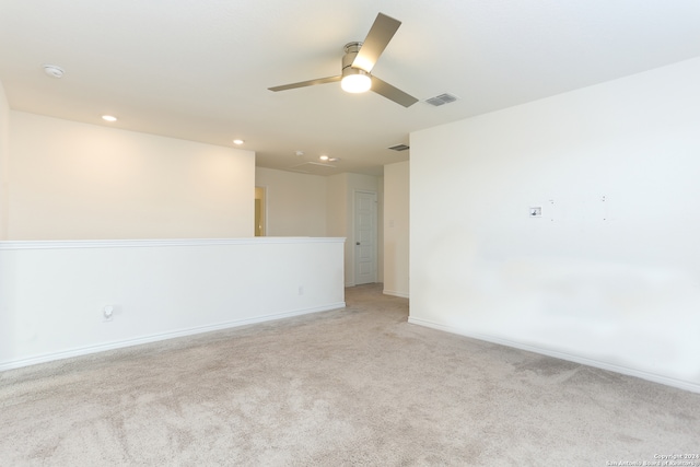 empty room with light carpet and ceiling fan