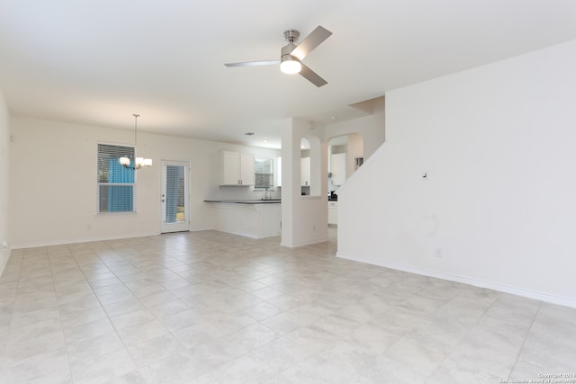 3254 Old Almonte Dr, San Antonio, TX 78224 - unfurnished living room with a ceiling fan, a chandelier, arched walkways, and baseboards