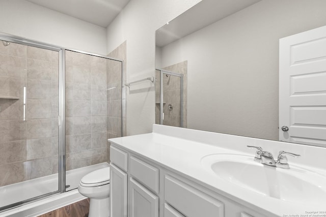 2087 Olivia Dr, New Braunfels, TX 78130 - bathroom featuring a shower stall, toilet, vanity, and wood finished floors