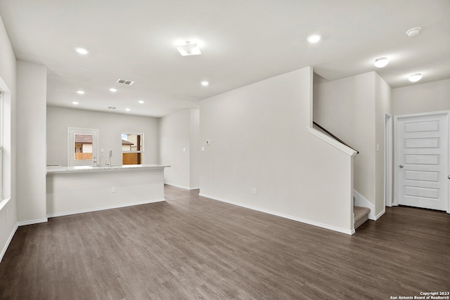 unfurnished living room featuring dark wood-type flooring