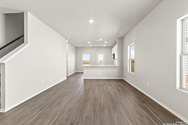 2087 Olivia Dr, New Braunfels, TX 78130 - unfurnished living room featuring dark wood finished floors, baseboards, and recessed lighting