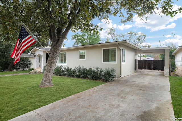 single story home featuring a front yard and a carport