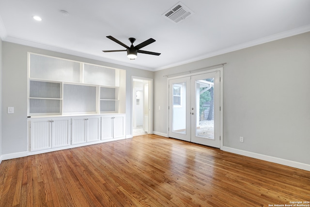 unfurnished living room with ceiling fan, french doors, wood-type flooring, and ornamental molding