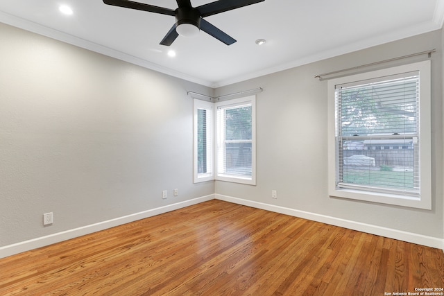 spare room featuring wood-type flooring, ceiling fan, and ornamental molding