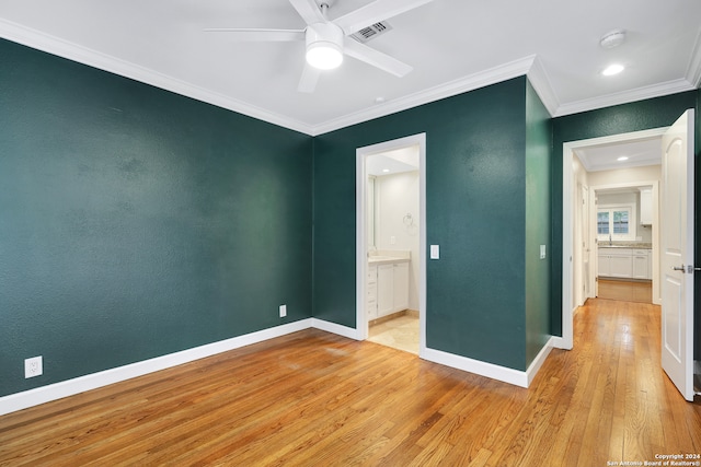 unfurnished bedroom with ceiling fan, ensuite bath, ornamental molding, and light hardwood / wood-style flooring