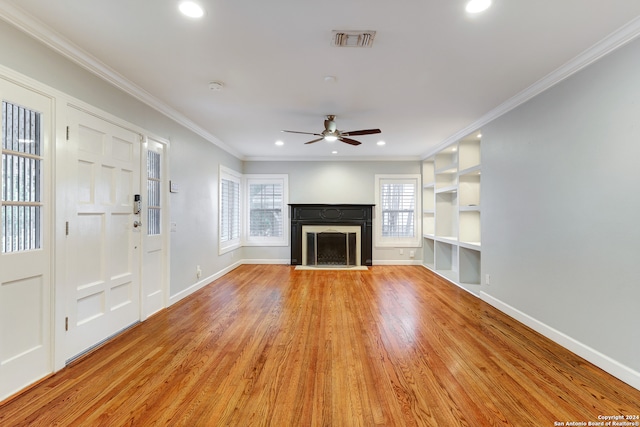 unfurnished living room with light hardwood / wood-style flooring, plenty of natural light, crown molding, and ceiling fan