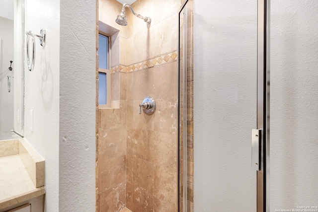 bathroom featuring vanity and a tile shower