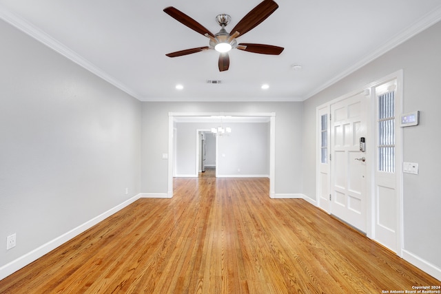 interior space with ceiling fan with notable chandelier, ornamental molding, and light hardwood / wood-style flooring