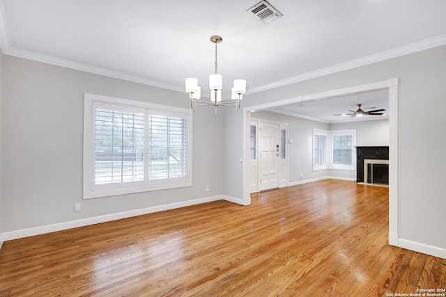 interior space featuring wood-type flooring, plenty of natural light, and crown molding