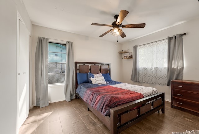 bedroom with a closet, ceiling fan, and hardwood / wood-style floors