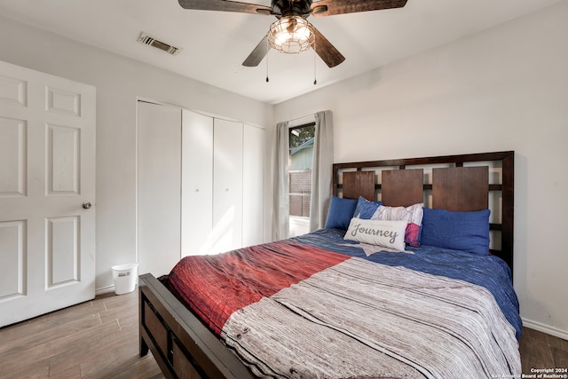 bedroom with a closet, ceiling fan, and hardwood / wood-style floors