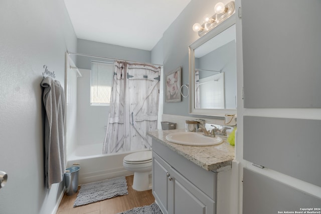 full bathroom featuring hardwood / wood-style flooring, vanity, toilet, and shower / bathtub combination with curtain