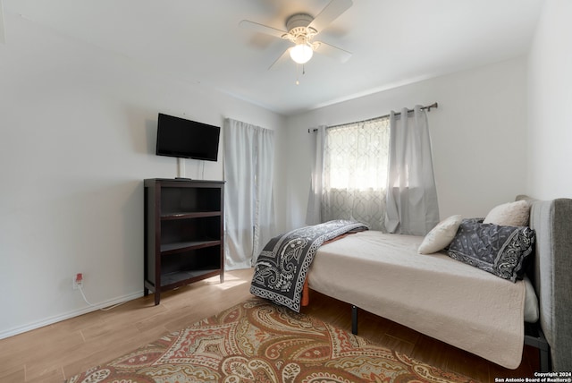 bedroom with light hardwood / wood-style flooring and ceiling fan