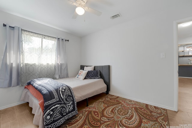 bedroom with light hardwood / wood-style floors and ceiling fan