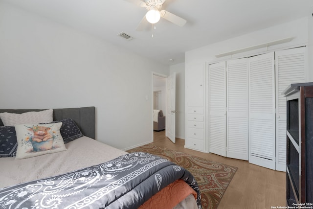 bedroom featuring a closet, light hardwood / wood-style floors, and ceiling fan