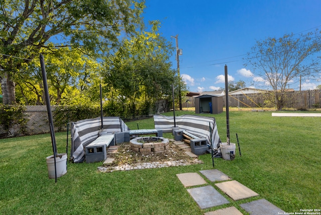 view of yard with a fire pit and a storage shed