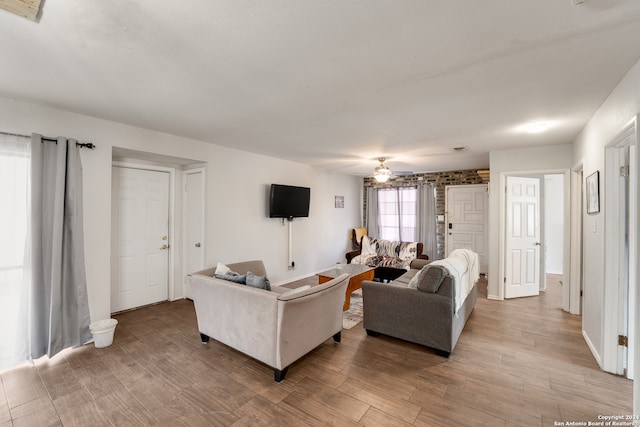 living room with ceiling fan and hardwood / wood-style flooring