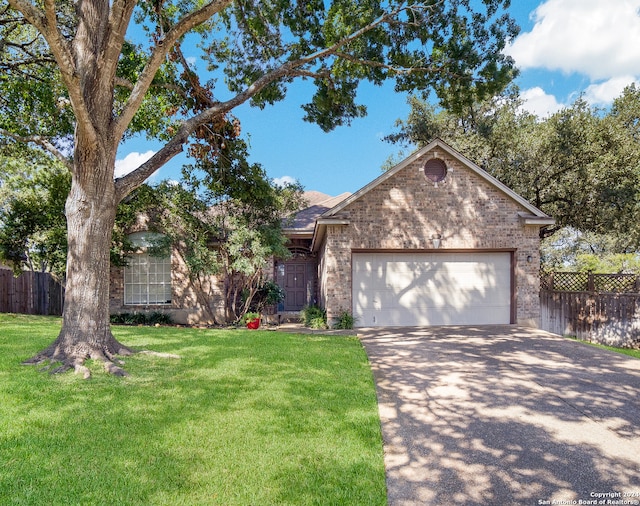 ranch-style home featuring a garage and a front lawn