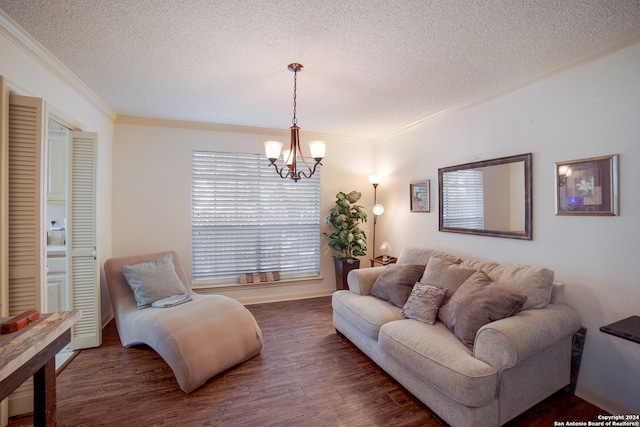 living room featuring a chandelier, ornamental molding, a textured ceiling, and dark wood-type flooring