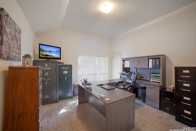 carpeted office space featuring a textured ceiling and lofted ceiling