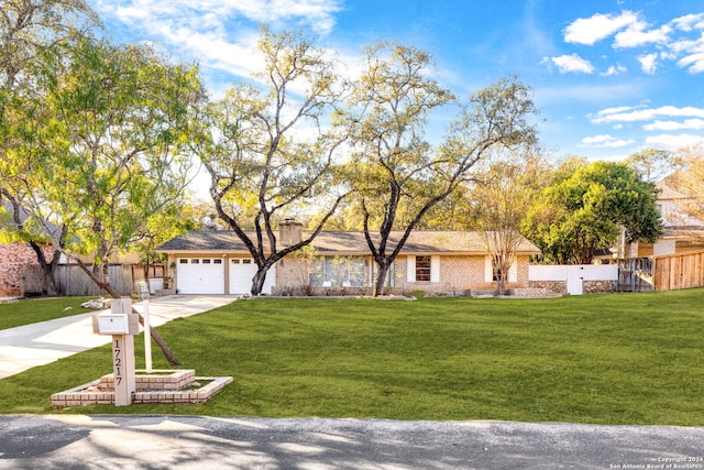 ranch-style home featuring a front yard and a garage