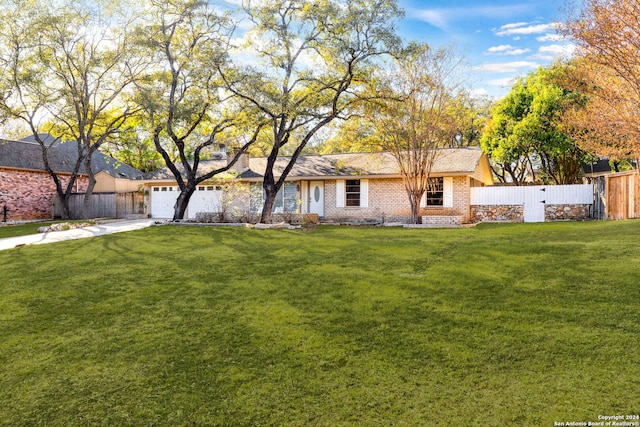 single story home with a front yard and a garage