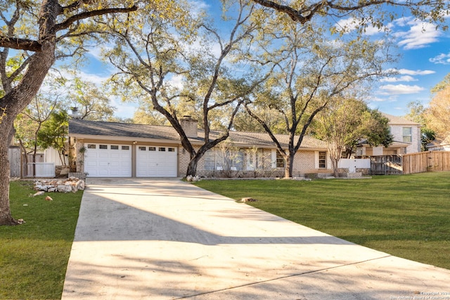 ranch-style home featuring a garage and a front yard