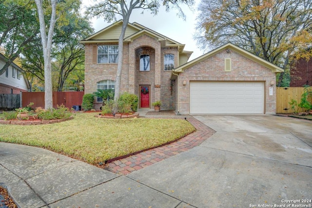 view of front of property with a garage and a front lawn