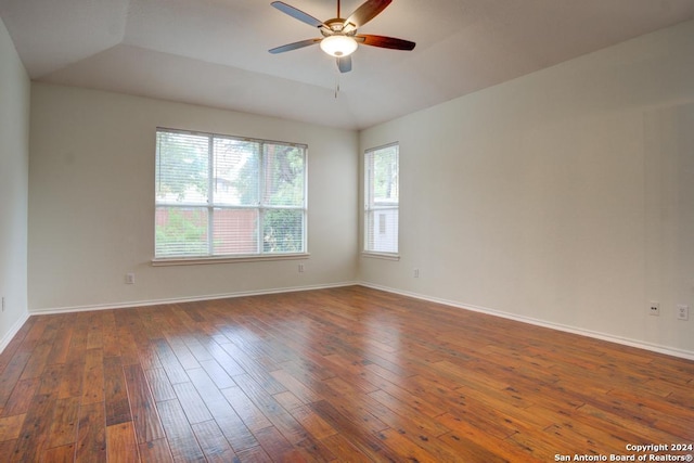 spare room with ceiling fan, lofted ceiling, and dark hardwood / wood-style flooring