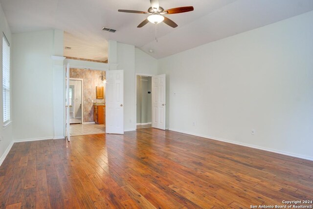 spare room featuring hardwood / wood-style flooring, vaulted ceiling, and ceiling fan