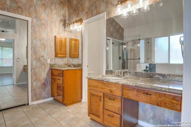 bathroom with tile patterned floors, vanity, and a shower with door