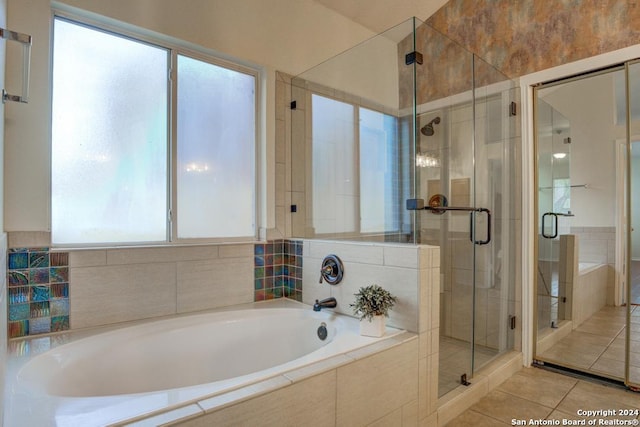 bathroom featuring tile patterned flooring and shower with separate bathtub