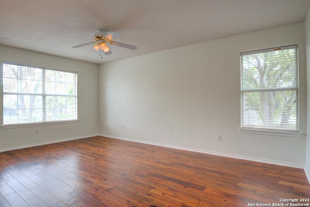 unfurnished room featuring dark wood-type flooring and ceiling fan