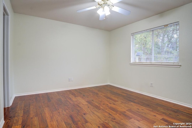 unfurnished room featuring dark hardwood / wood-style flooring and ceiling fan