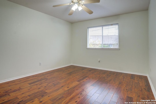 empty room featuring ceiling fan and dark hardwood / wood-style flooring