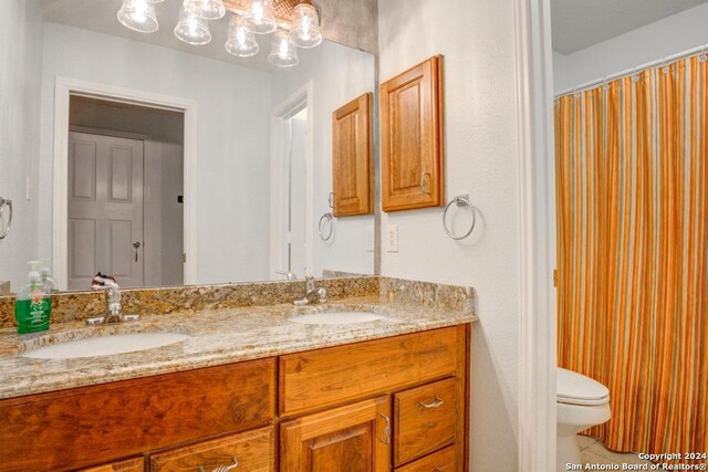 bathroom featuring vanity, tile patterned floors, and toilet