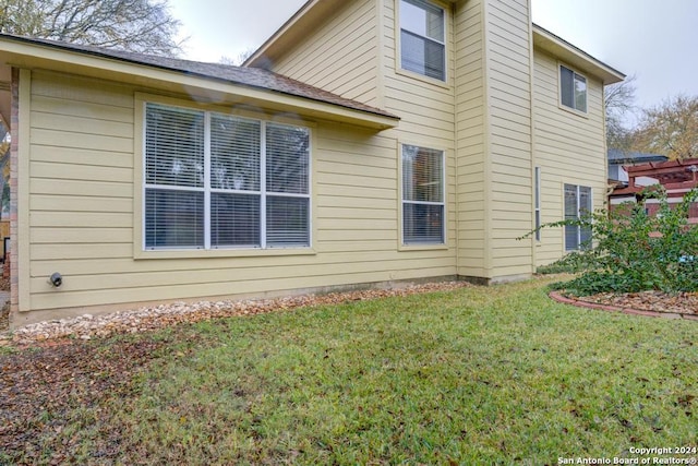 view of property exterior featuring a lawn