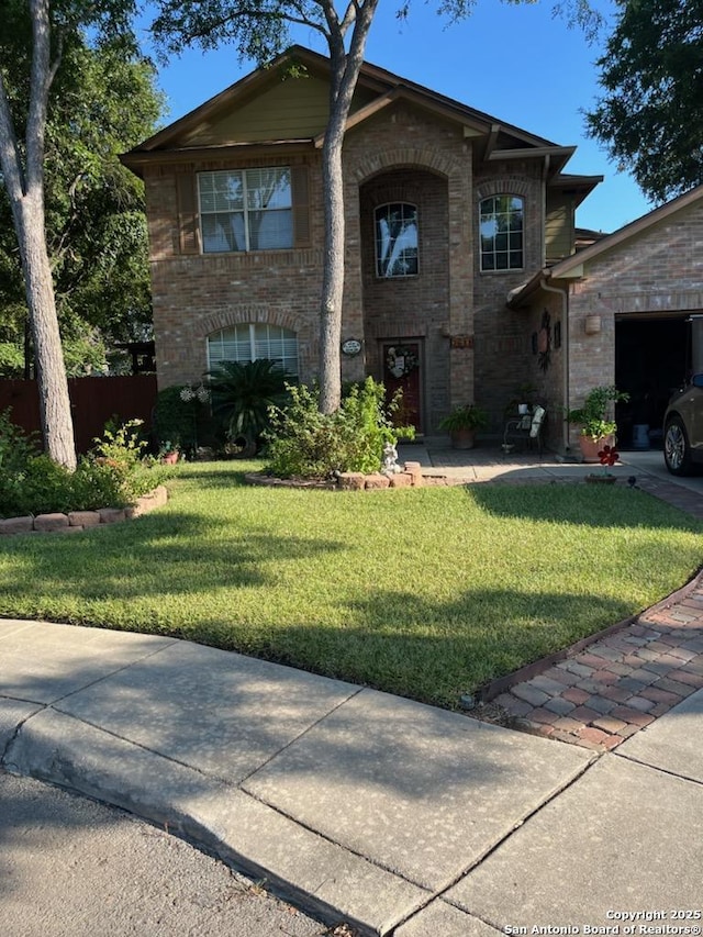 view of front of property with a garage and a front lawn