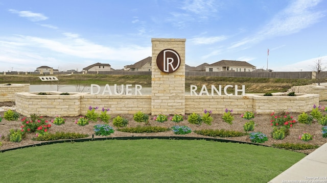 community sign featuring a lawn