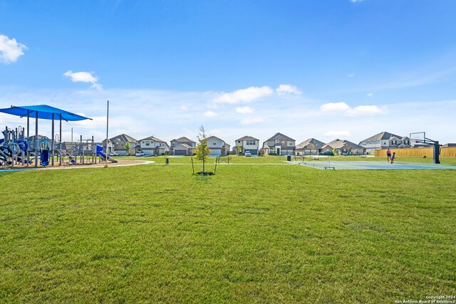 exterior space with a playground and a yard