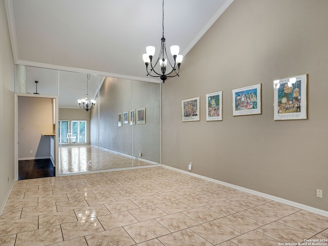 spare room featuring crown molding, a towering ceiling, and an inviting chandelier