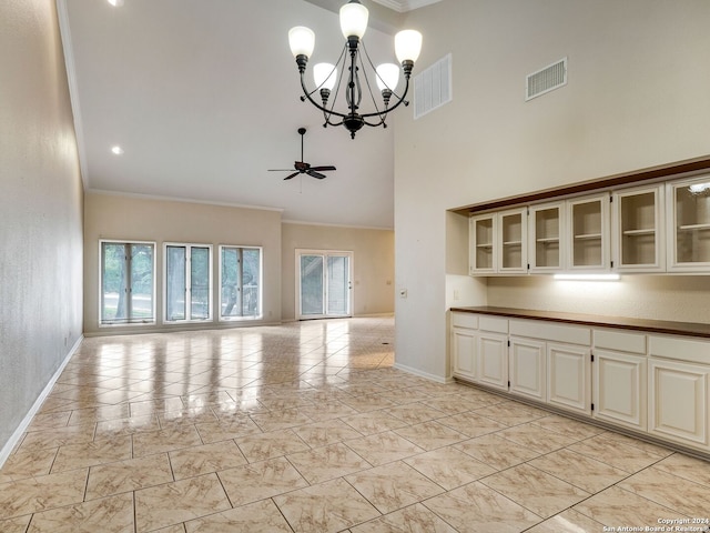 interior space with crown molding, a towering ceiling, and ceiling fan with notable chandelier