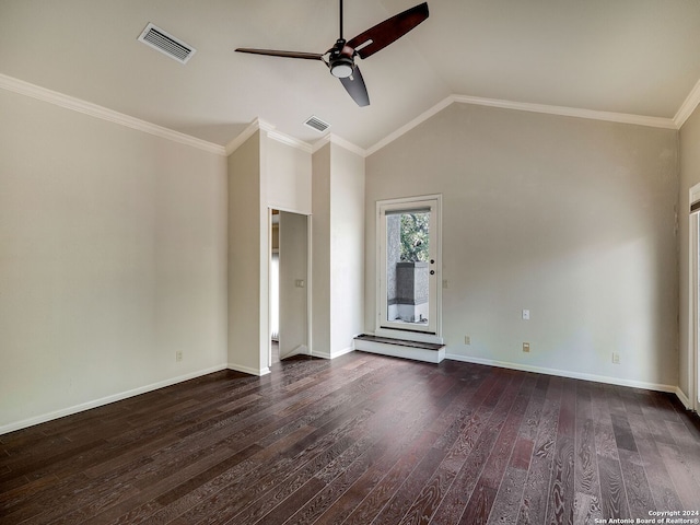 empty room featuring crown molding, dark wood-type flooring, and vaulted ceiling